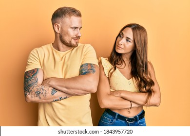 Young Couple Of Girlfriend And Boyfriend Hugging And Standing Together Looking To The Side With Arms Crossed Convinced And Confident 