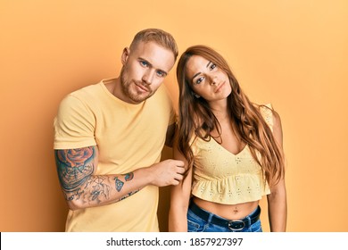 Young Couple Of Girlfriend And Boyfriend Hugging And Standing Together Looking Sleepy And Tired, Exhausted For Fatigue And Hangover, Lazy Eyes In The Morning. 