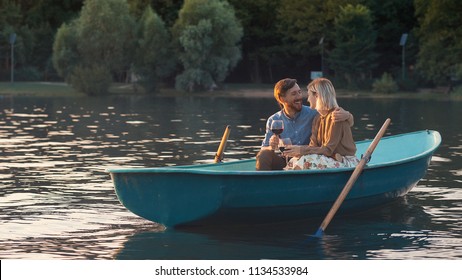 Young couple with glasses of wine in a boat