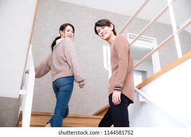 Young Couple Going Up Stairs.