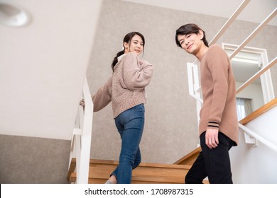 Young Couple Going Up Stairs.