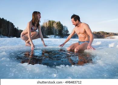 Young Couple Going To Swim In The Winter Lake In The Ice Hole