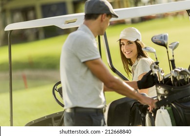 Young Couple At Golf Cart