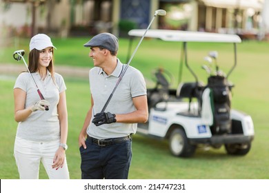 Young Couple At Golf Cart