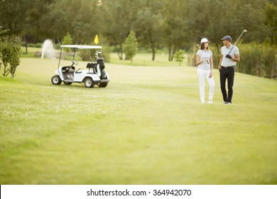 Young Couple At Golf Cart