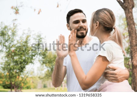 A young couple happy giving high five energetic and cheering in the park