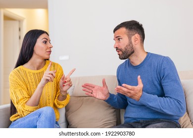 Young Couple Have Disagreement at Home. Quarrel in Young Family. Sad Woman. Divorce Concept. Upset Husband. Relationship between People Concept. Conversation in the livingroom