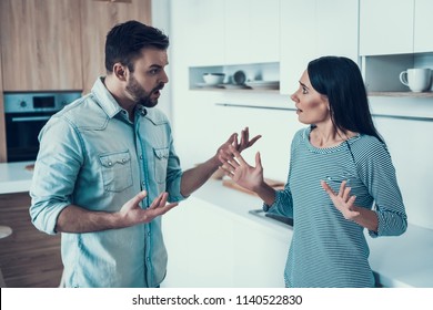 Young Couple Have Disagreement in Kitchen at Home. Quarrel in Young Family. Sad Woman. Divorce Concept. Upset Husband. Relationship between People Concept. Conversation in Kitchen. - Powered by Shutterstock