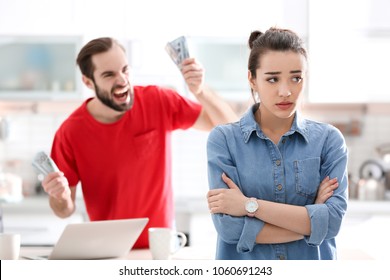 Young Couple Having Argument About Family Budget In Kitchen