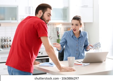 Young Couple Having Argument About Family Budget In Kitchen