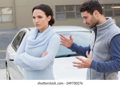 Young Couple Having An Argument Outside Their Car