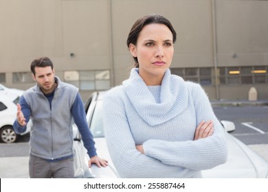 Young Couple Having An Argument Outside Their Car