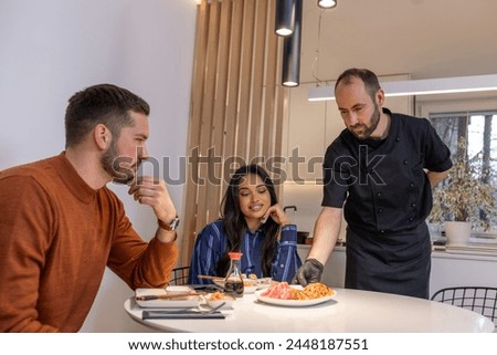 Private chef serving seafood dishes in a modern kitchen
