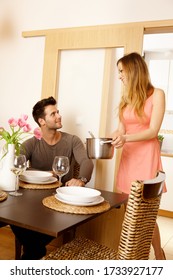 Young Couple Having Dinner At Home, Woman Serving Soup.