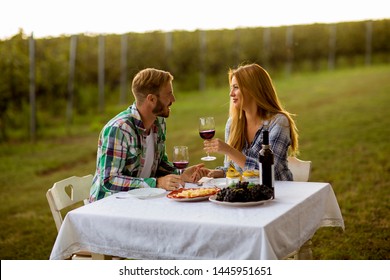 Young couple having dinner at vineyard at countryside - Powered by Shutterstock