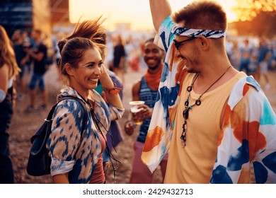 Young couple having fun and dancing on a music concert in summer.  - Powered by Shutterstock