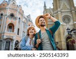 Young couple having fun on their vacation. Looking at the monuments and buildings. Travelling concept.