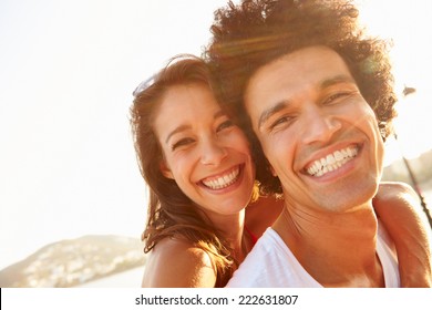 Young Couple Having Fun On Beach Holiday Together