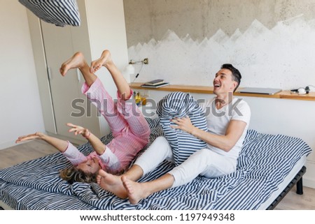 Similar – Image, Stock Photo Man showing baby clothes to pregnant woman