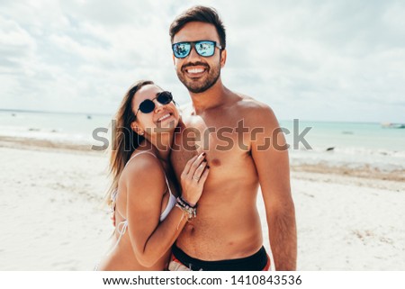 Young couple having fun on tropical beach