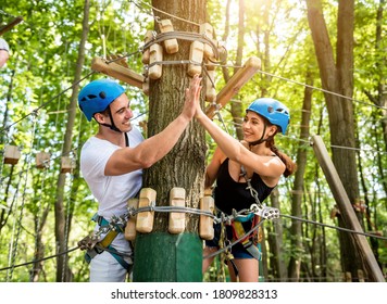 Young couple having fun time in adventure rope park. - Powered by Shutterstock