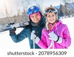 Young couple having fun while winter skiing