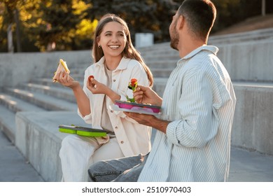 Young couple having lunch outdoors - Powered by Shutterstock