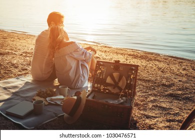 A young couple having a picnic at the beach