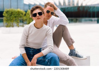 Young Couple Having Problems In Their Relationship. Man And Woman Friends In Sunglasses Sitting Bench In City Unhappy Emotions. Relationships Problem.