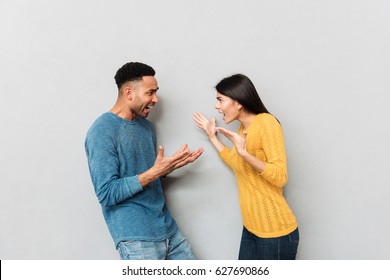 Young Couple Having A Quarrel. African Man And Angry Woman Scolding At Each Other Isolated