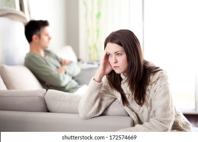 Young couple having relationship difficulties, shallow depth of field focus on foreground