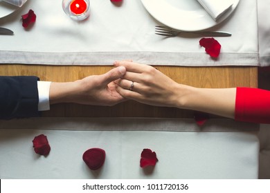 Young Couple Having Romantic Dinner In The Restaurant Wearing A Proposal Ring Top View