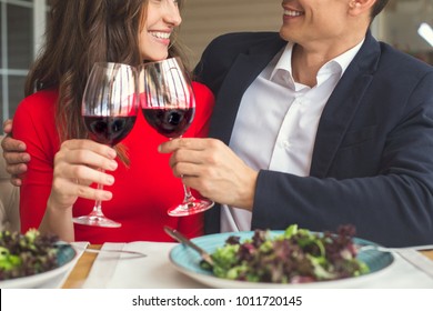 Young Couple Having Romantic Dinner In The Restaurant Cheers Close-up