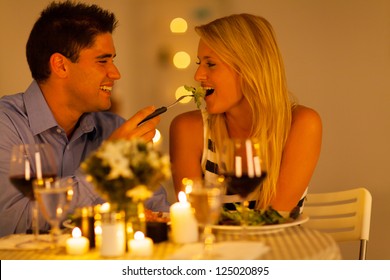 Young Couple Having Romantic Dinner Together In A Restaurant