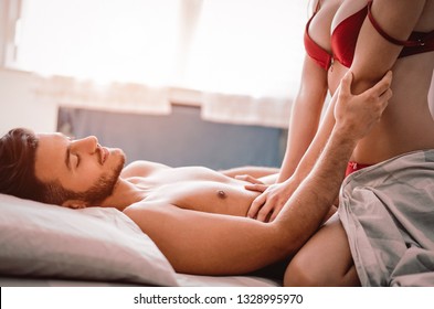 Young horny couple having romantic sex on the bed