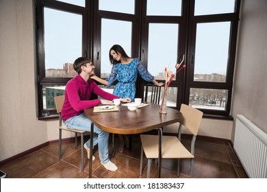 Young Couple Having Some Coffee In The Kitchen