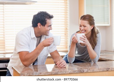 Young Couple Having Some Coffee In The Kitchen