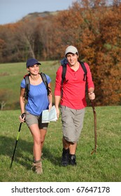 Young Couple Hiking In Countryside