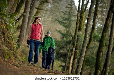 Young Couple Hiking With Dog.