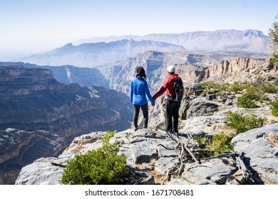 Young Couple Hiking In Jabel Shams, Wadi Ghul, Grand Canyon Of Arabia, Oman, Middle East, Asia