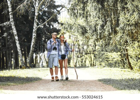 Similar – Women friends laughing while walking in forest