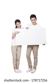 	Young Couple Holding A Blank Sign	