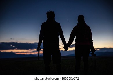 Young Couple Holding Hands Watching The Neowise Comet On The Sky. 