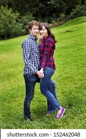 Young Couple Holding Hands Wearing Jeans