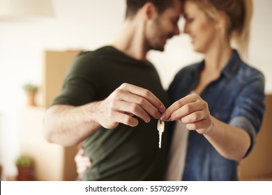 Young couple holding up new house key