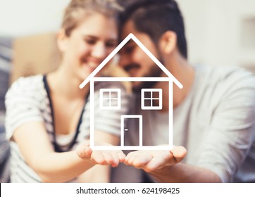 Young Couple Holding Their New, Dream Home In Hands