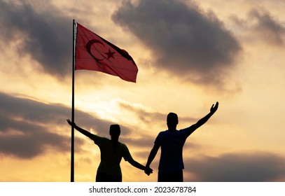 Young Couple Holding Turkish National Flag And Waving It In The Sky.