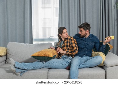 Young Couple At Home Have A Problem And Argue Due To Jealousy Caused By Chatting And Flirting Via Social Media Networks On Smart Phones, Relationship Difficulties Problems And Distrust