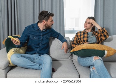 Young Couple At Home Have A Problem And Argue Due To Jealousy Caused By Chatting And Flirting Via Social Media Networks On Smart Phones, Relationship Difficulties Problems And Distrust