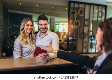 Young Couple At The Hotel Reception